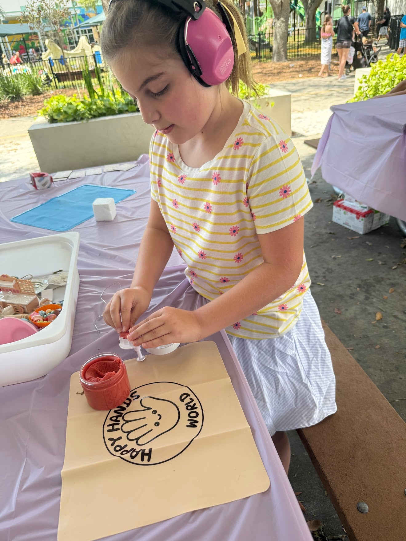 Child doing craft outdoors