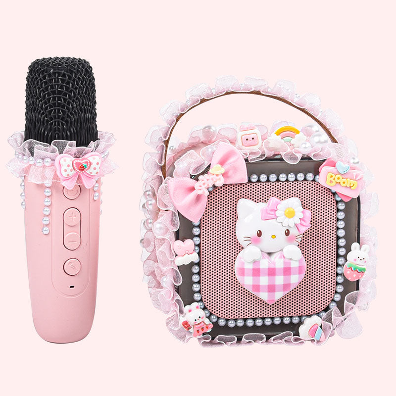 Pink microphone and speaker with Hello Kitty design on a white background