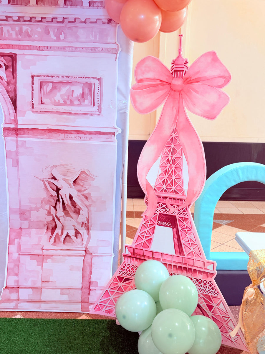 Pink Eiffel Tower decoration with balloons and a blurred background
