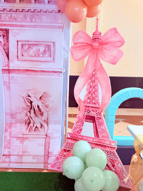 Pink Eiffel Tower decoration with balloons and a blurred background