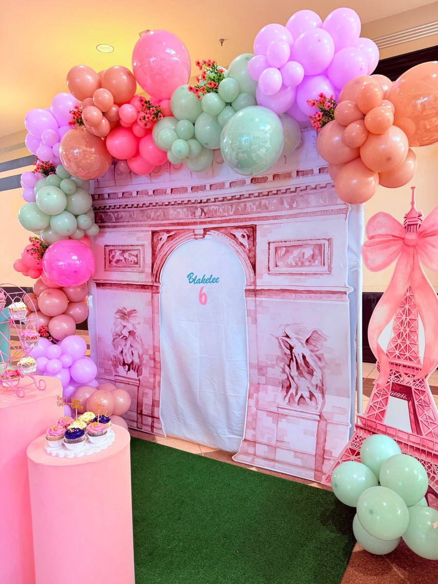 Decorative setup with balloons and a Paris-themed backdrop