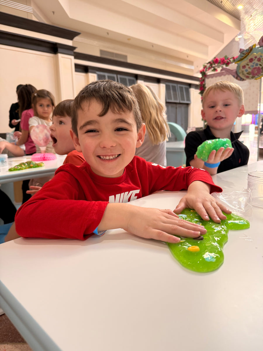 Children playing with green toys in a store setting