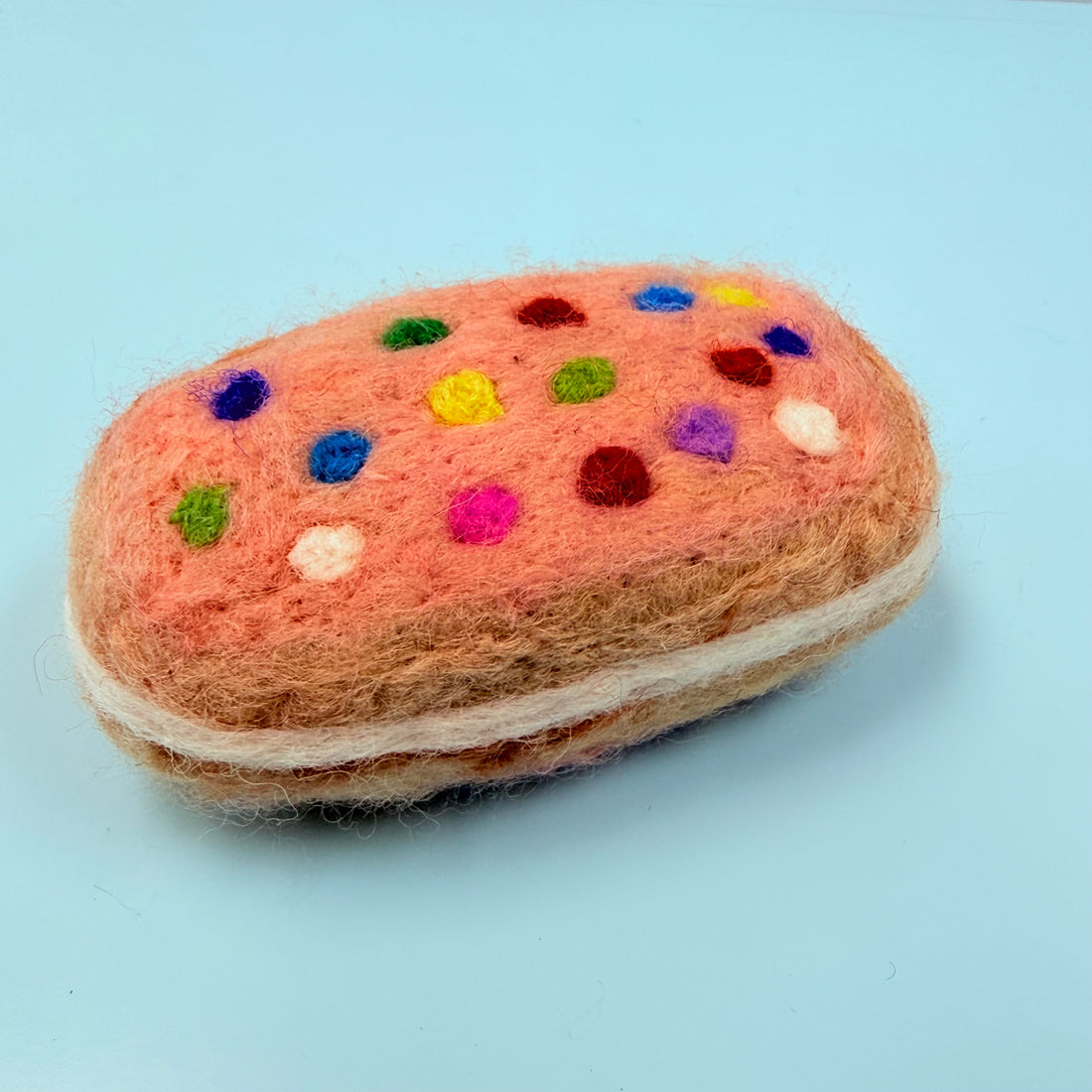 Felted toy resembling a cookie