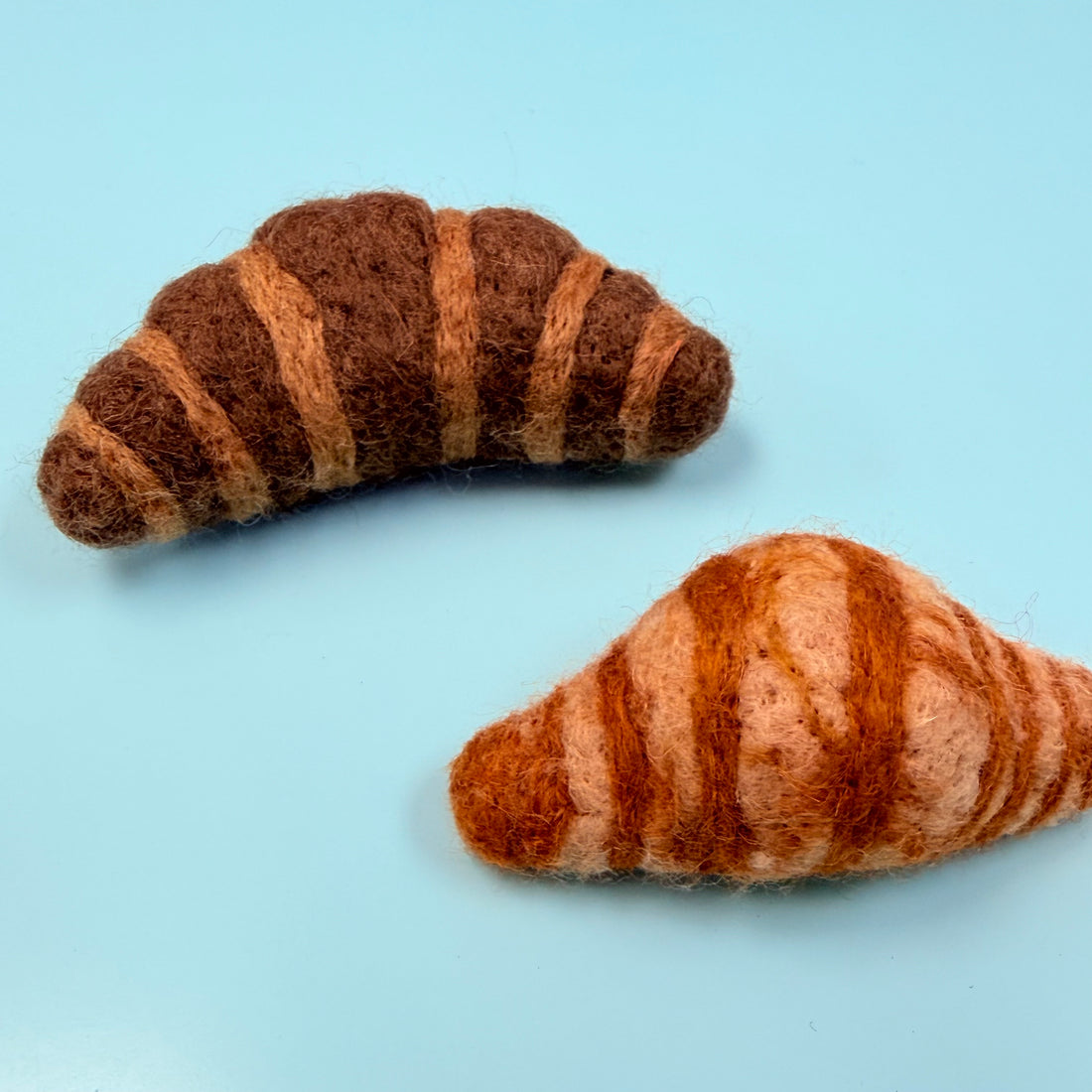 Two felted croissant toys 