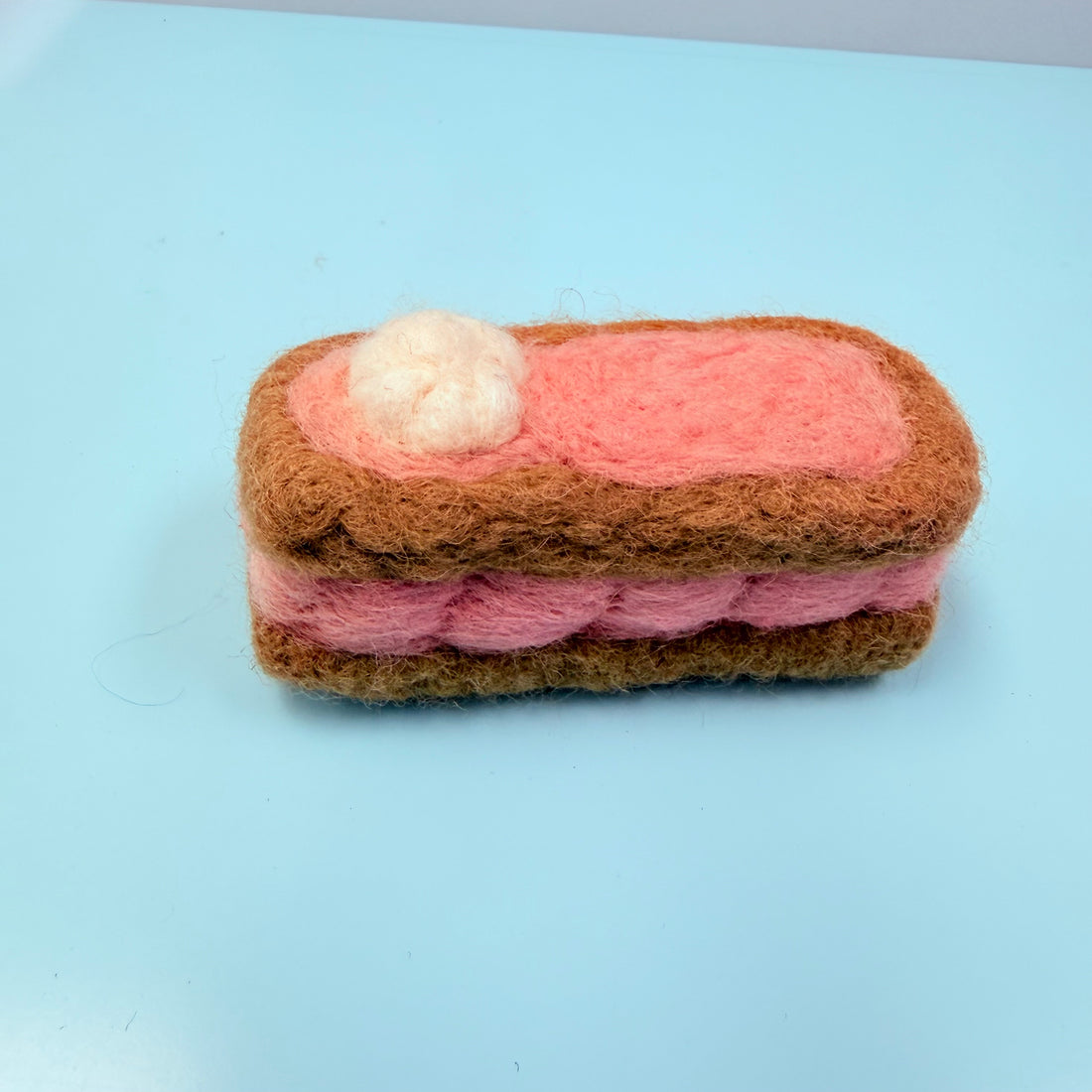Felted toy resembling a sandwich
