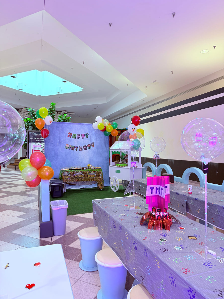 Colorful indoor play area with slides and balloons